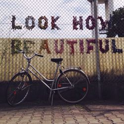 Bicycle parked on wall