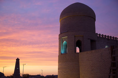 Low angle view of building against sky during sunset