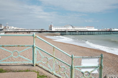 View of beach by buildings against sky