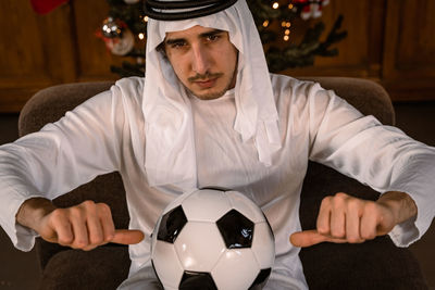 Midsection of man playing soccer ball