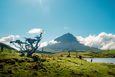 Scenic view of mountains against blue sky