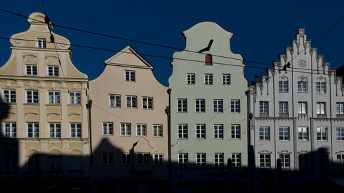 Low angle view of buildings against blue sky