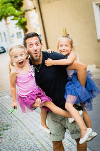 Portrait of happy family standing on road