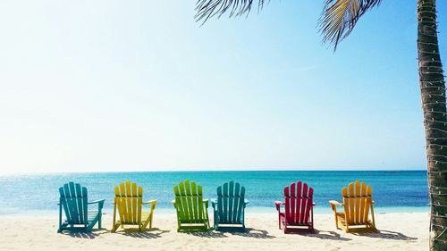 Multi colored deck chairs at beach