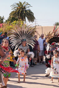 People standing in front of palm trees