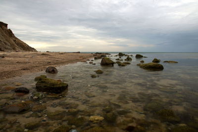 Rocks on beach against sky