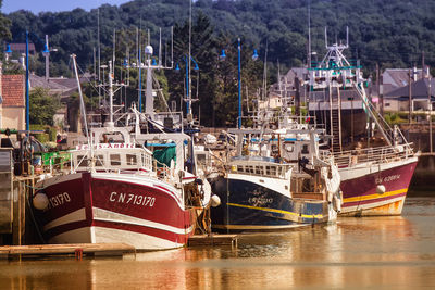 Fishing boats moored at harbor