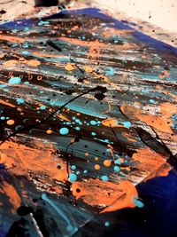 Abstract painting on paper, colorful paint splatters and brush strokes, wet acrylic paint
