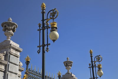 Low angle view of street light against blue sky