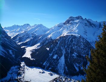 Scenic view of snowcapped mountains against sky