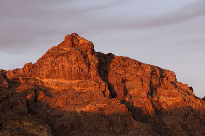 Low angle view of rocky mountains against sky