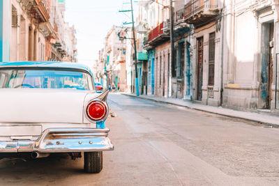 Car on street against buildings in city