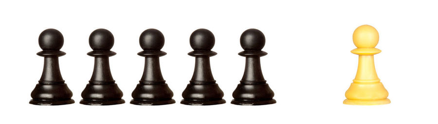 Close-up of chess pieces against white background