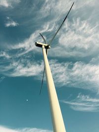 Low angle view of wind turbine against cloudy sky