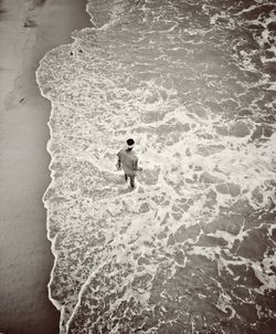 High angle view of man standing on beach