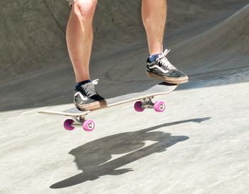 Low section of man skateboarding on skateboard