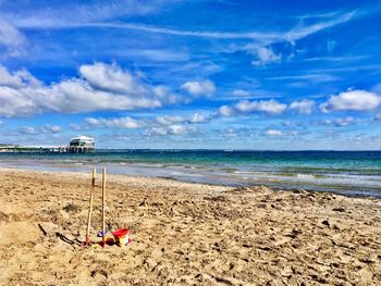 Scenic view of beach against blue sky