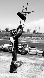 Full length of man standing on road against sky