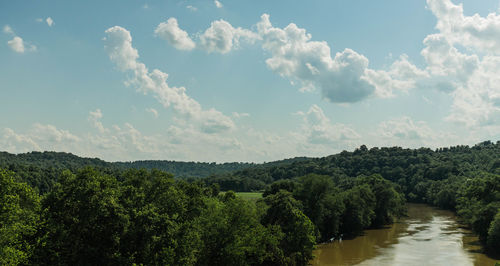 View of calm river against cloudy sky