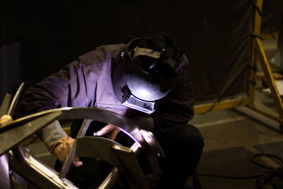 Man welding metal at factory