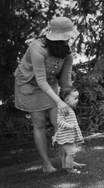 Full length of girl standing on bench