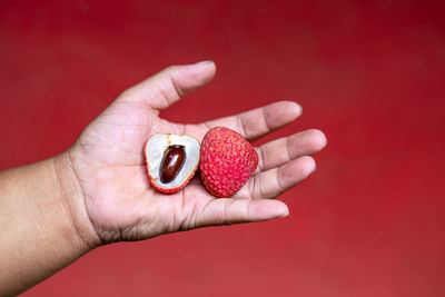 Close-up of hand holding strawberries