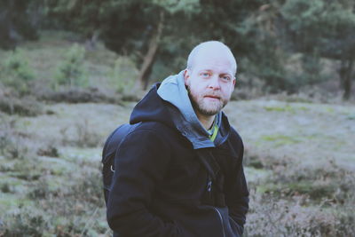 Portrait of man standing at forest