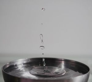 Close-up of drop falling on water