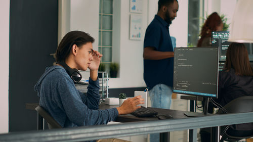 Side view of businesswoman working at office