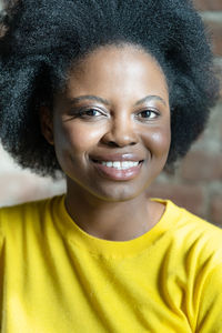 Close-up portrait of smiling young woman