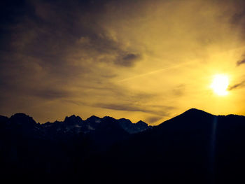 Scenic view of silhouette mountains against sky during sunset