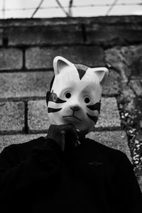 Man wearing mask against wall