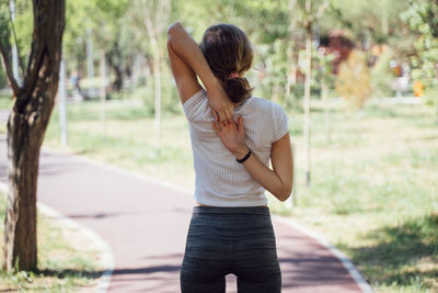 Full length of woman standing on road