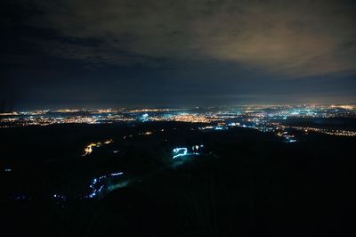 High angle view of city lit up at night