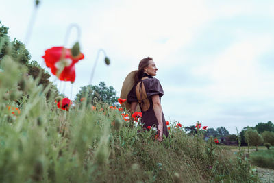 Rear view of woman standing on field