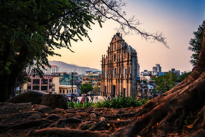 Buildings against sky at sunset