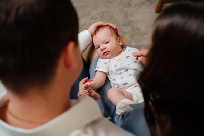 High angle view of mother and father with son at home