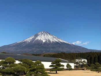 Scenic view of snowcapped mountain against blue sky