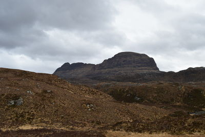 Scenic view of mountains against cloudy sky