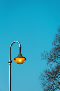 Low angle view of street light against clear blue sky