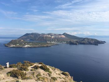 Scenic view of sea and mountains against sky