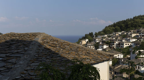 Buildings in town against sky