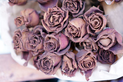 A bouquet of brown dried roses close up photo in vintage tone