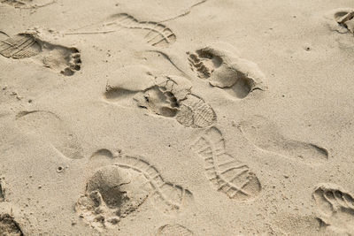 High angle view of footprints on sand