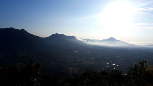 Scenic view of mountains against blue sky