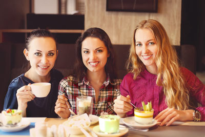 Young women having food in restaurant