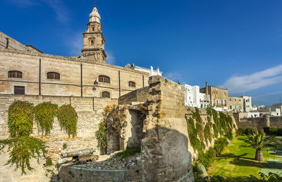 Low angle view of historical building against blue sky