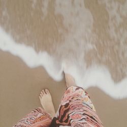 Close-up of woman standing on tiled floor