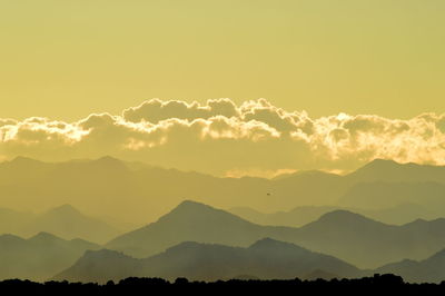 Scenic view of silhouette mountains against sky during sunset