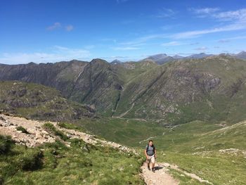 Rear view of man on mountain against sky